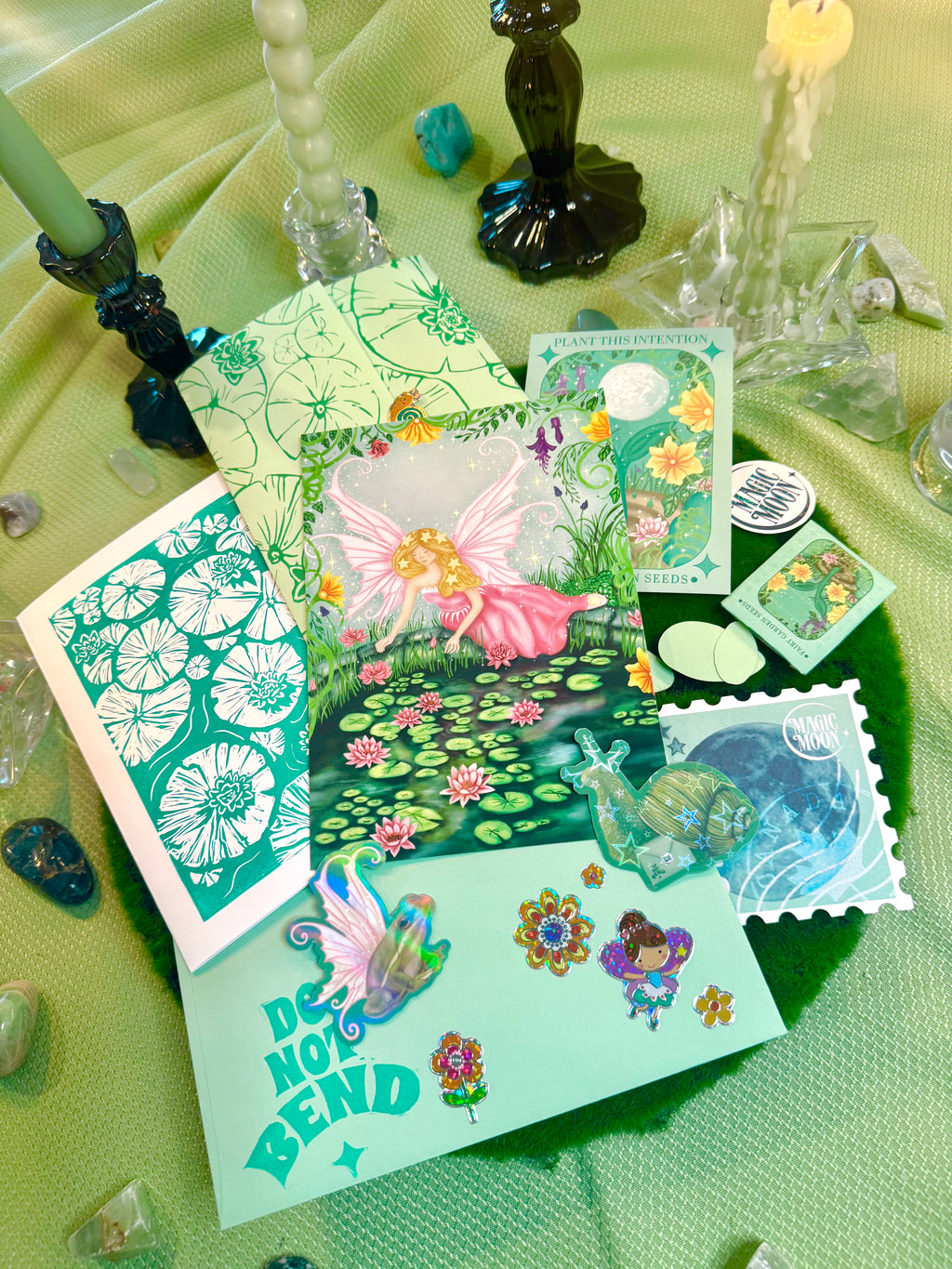 Collection of colorful greeting cards with nature-themed designs on a green surface.