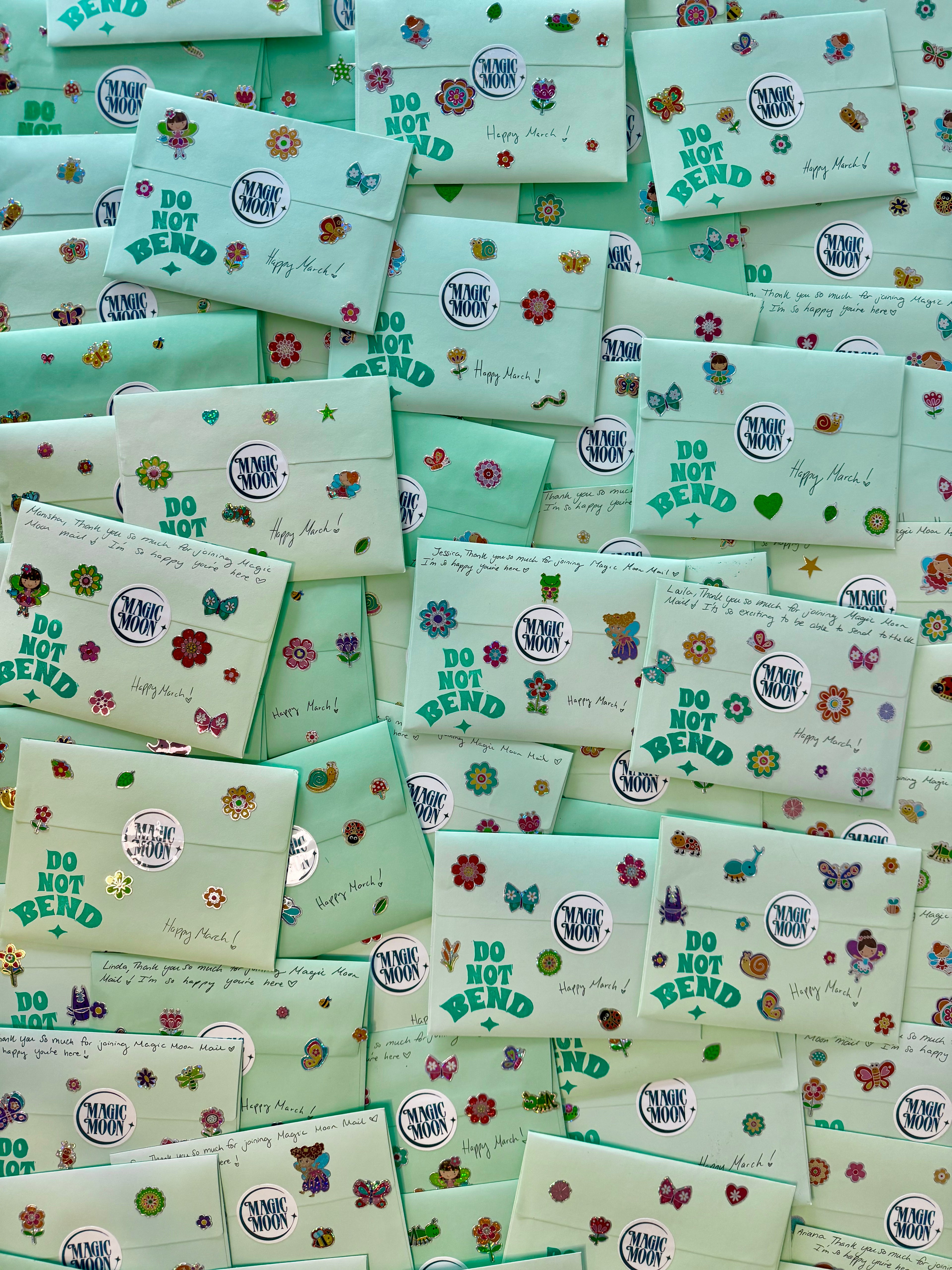 Stack of green envelopes with floral designs and 'Do Not Bend' labels.