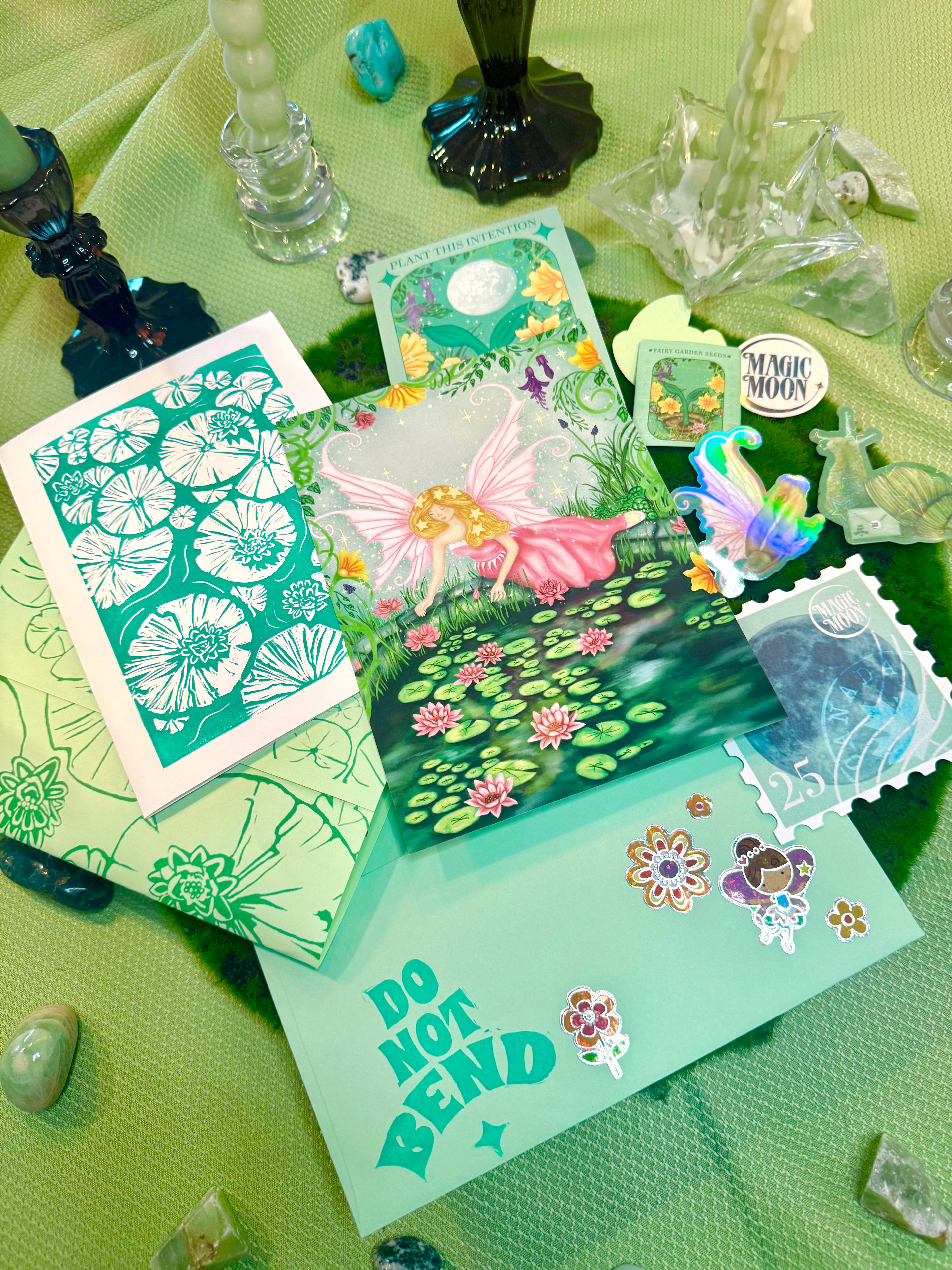 Collection of decorative cards and figurines on a green surface with 'Do Not Bend' text.