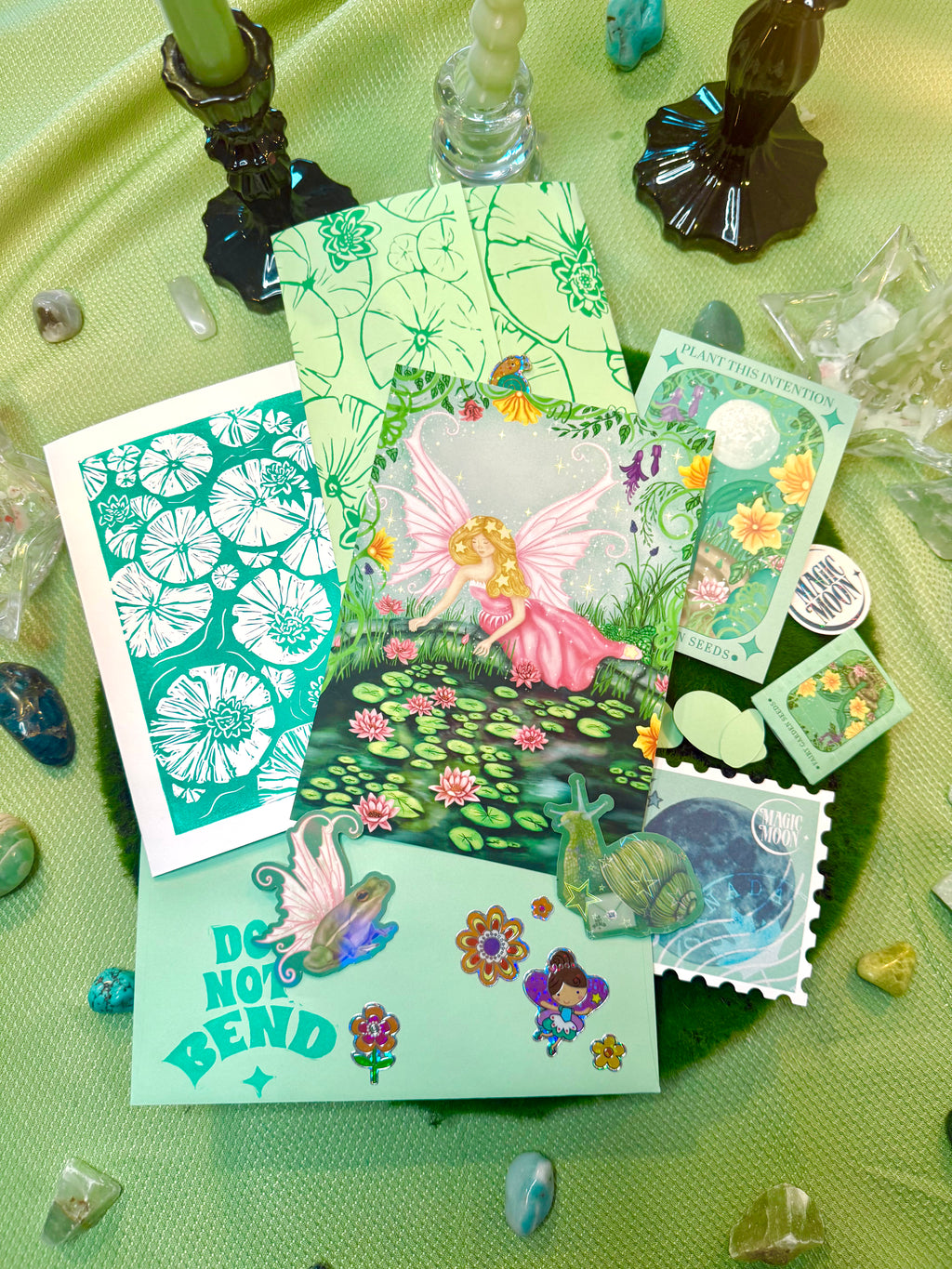 Set of fairy-themed cards and stickers on a green surface with decorative elements.