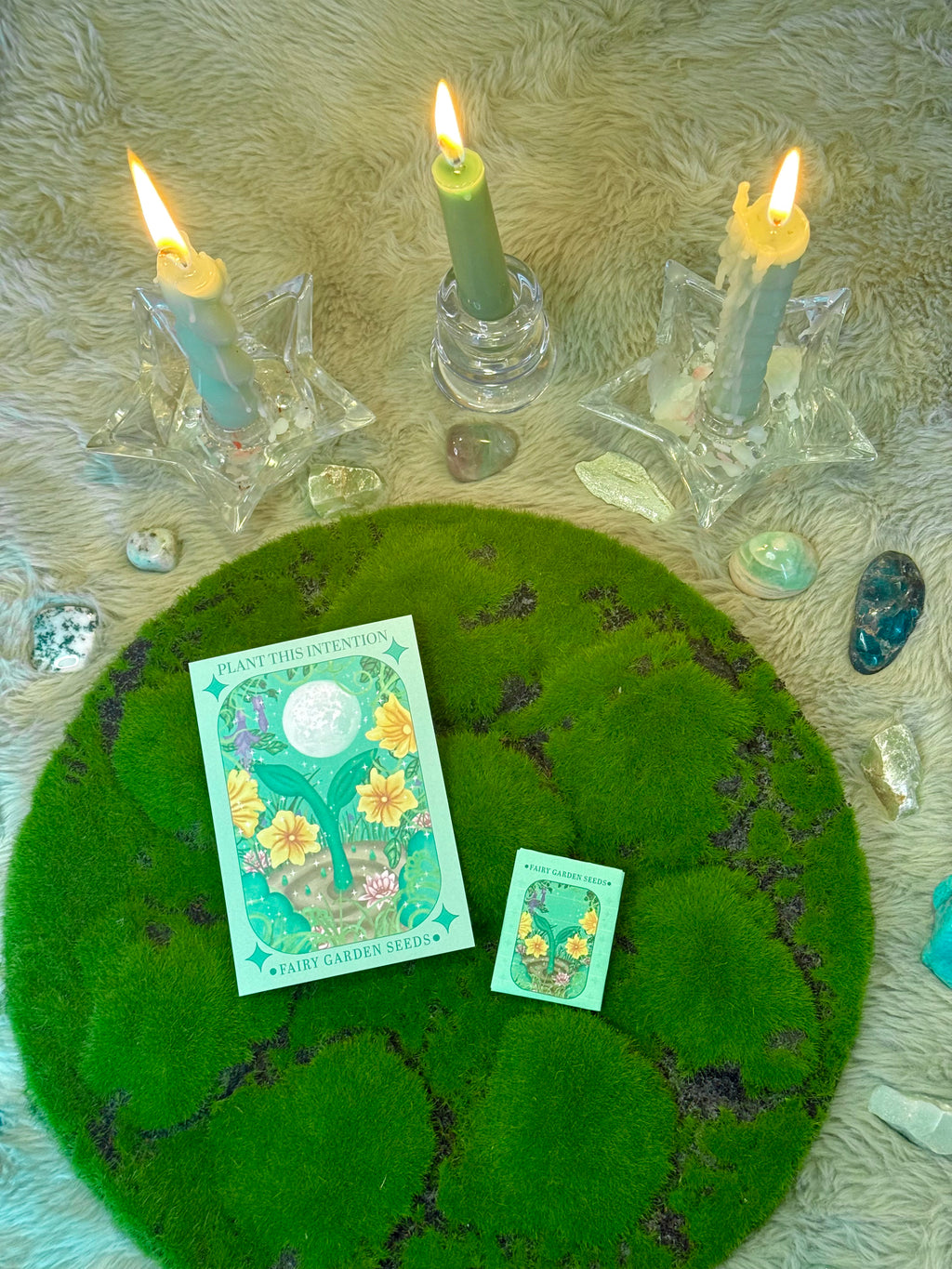 Wiccan altar setup with candles, crystals, and tarot cards on a textured surface.